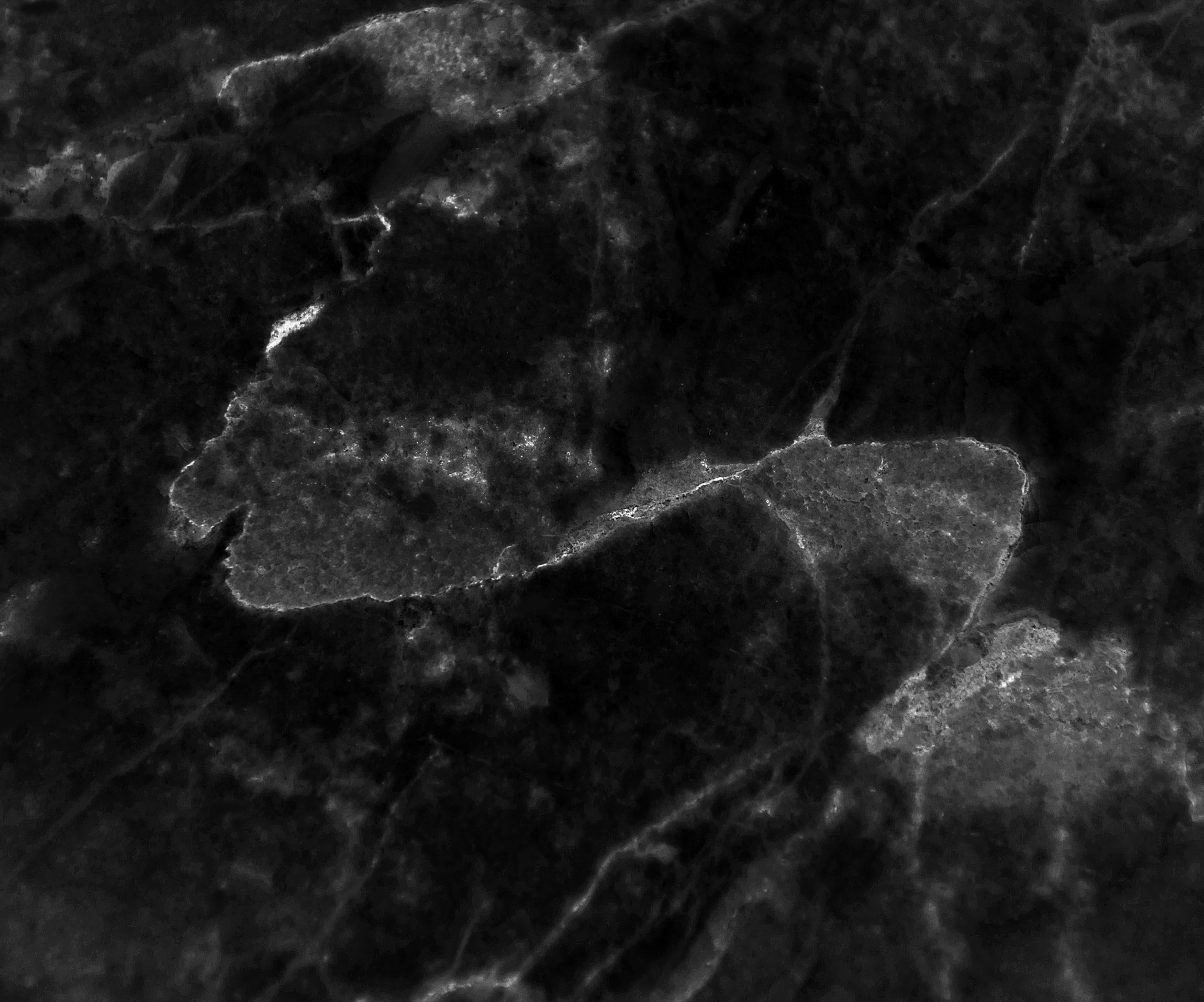 Black marble with light patterns and textures.