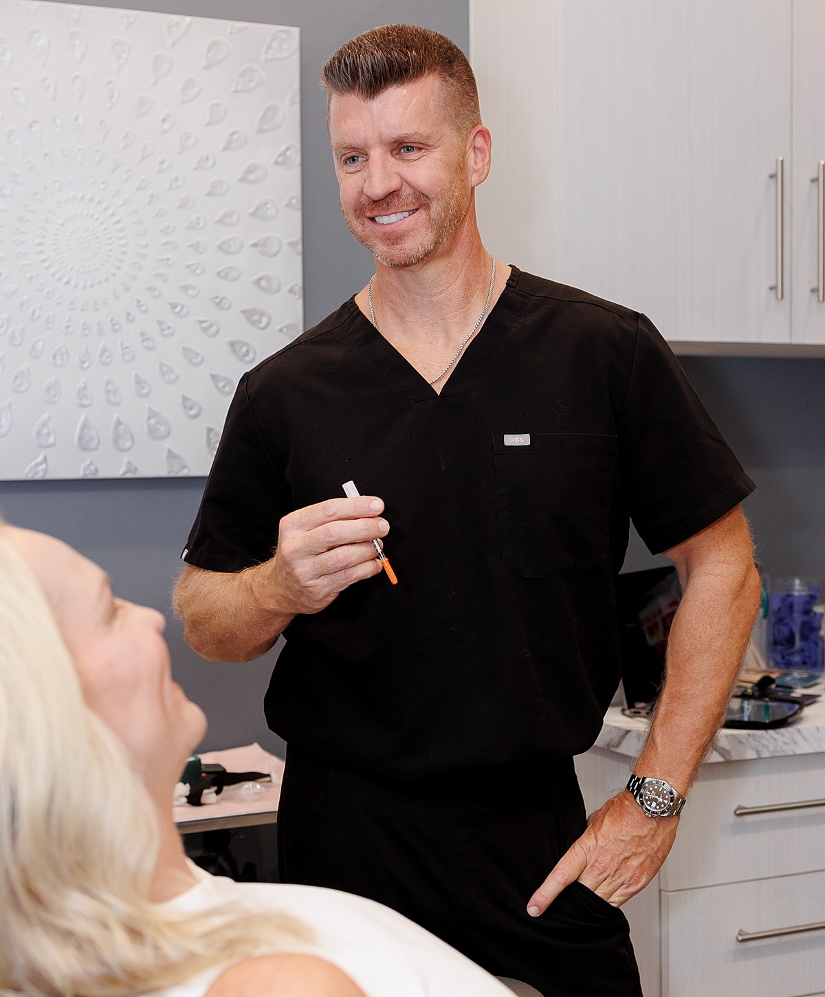 Doctor smiling while consulting a patient.