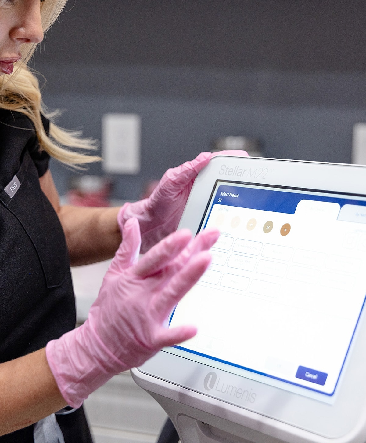 User interacting with medical device touchscreen display.