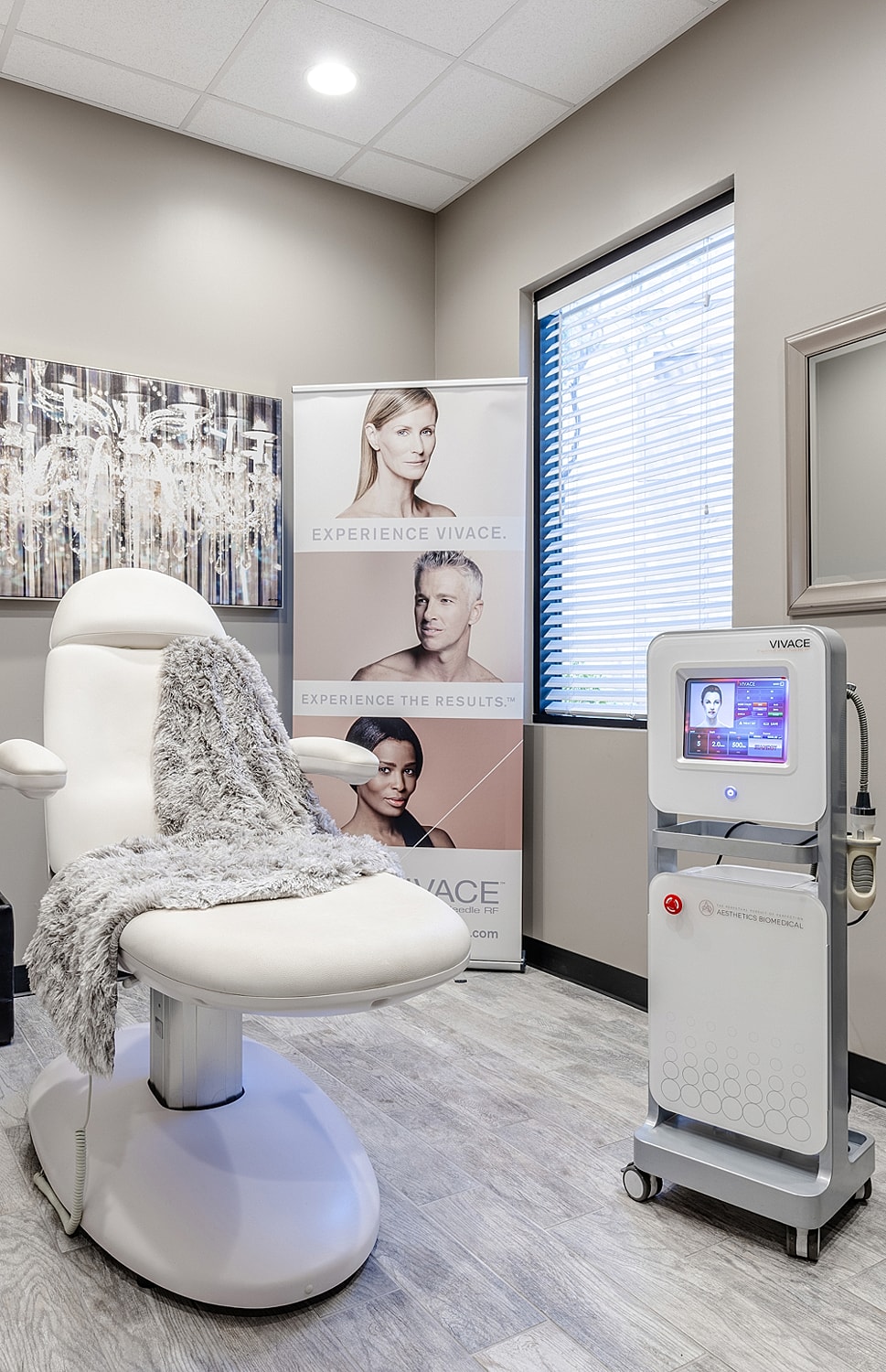 Aesthetic treatment room with equipment and chair.