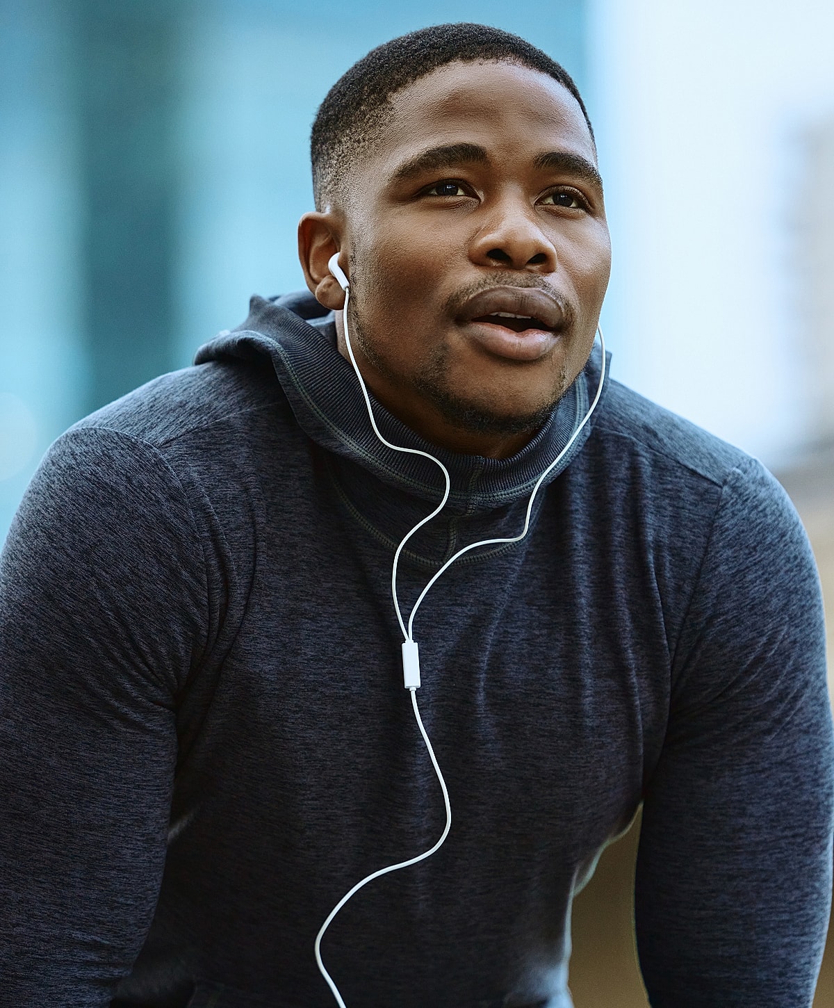 Man listening to music while exercising outdoors.