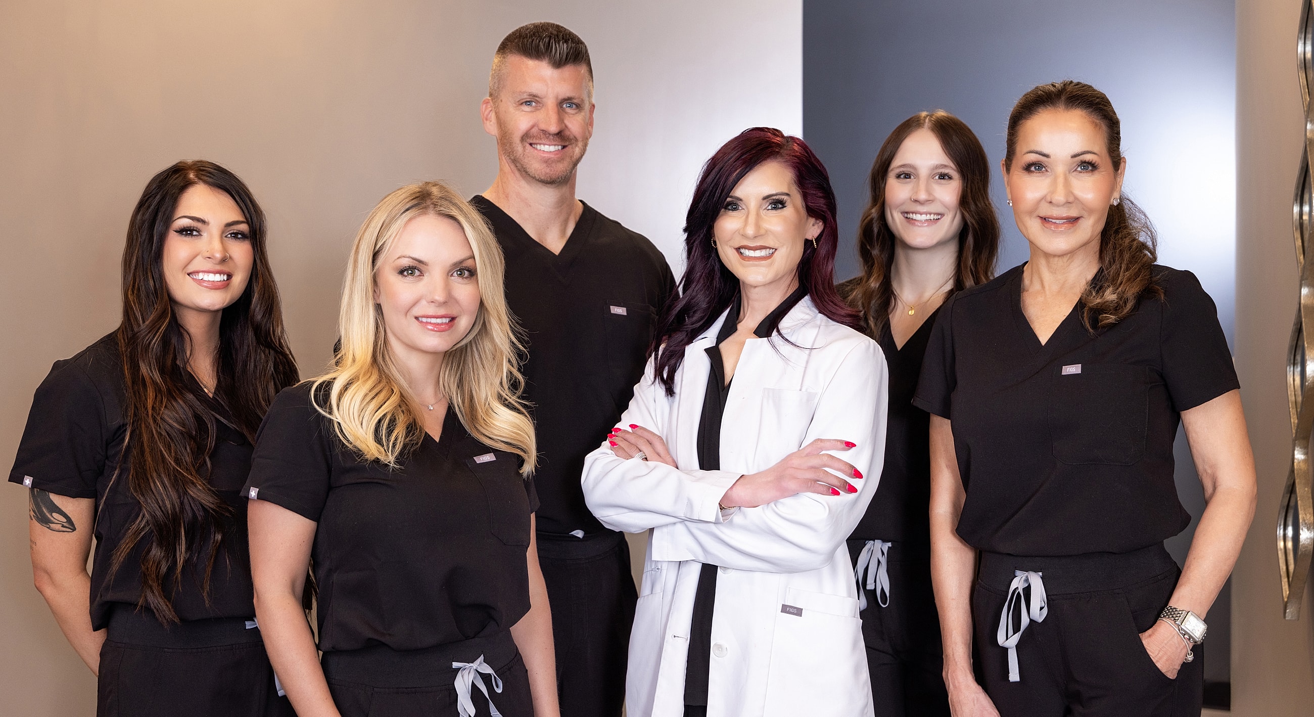 Medical team posing together in clinic setting.
