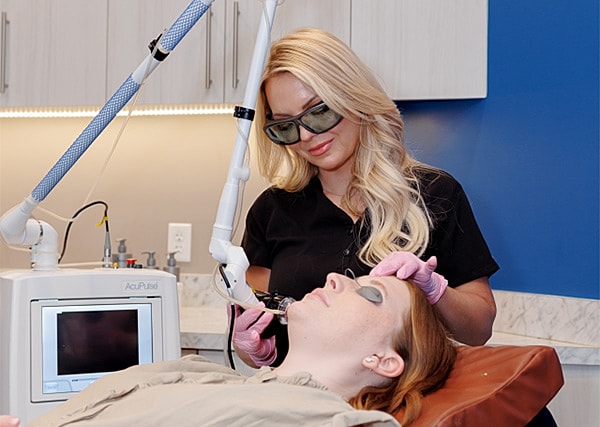 Client receiving facial treatment in a clinic.